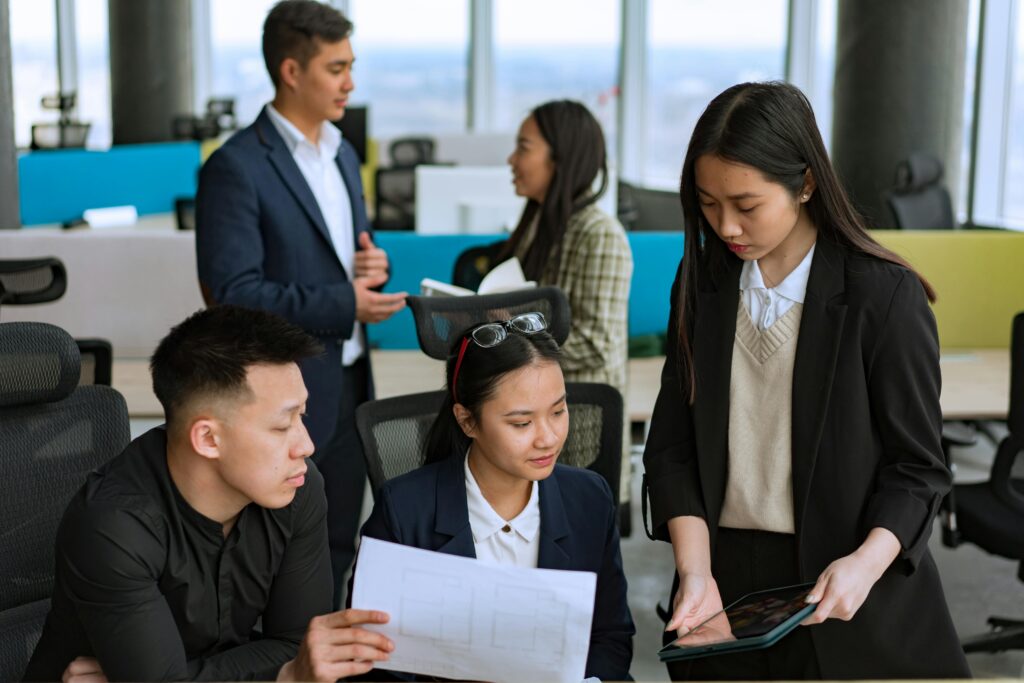 A diverse group of professionals brainstorming ideas together in a modern office setting.